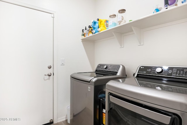 washroom with independent washer and dryer and laundry area