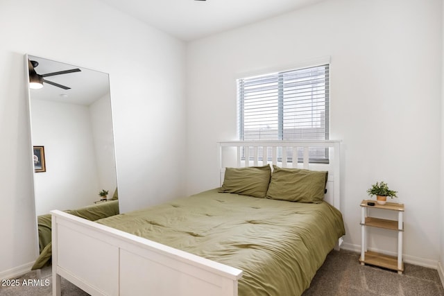 bedroom with a ceiling fan, carpet, and baseboards