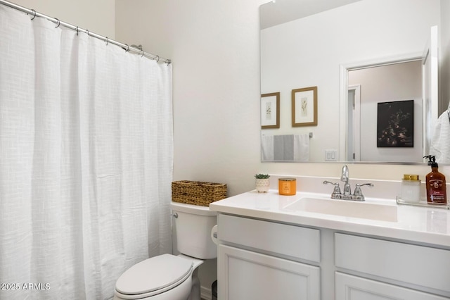 full bathroom with vanity, a shower with shower curtain, and toilet