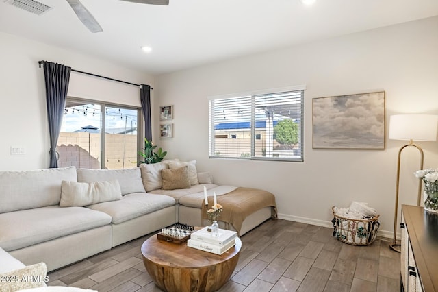 living area with a ceiling fan, baseboards, visible vents, wood finish floors, and recessed lighting