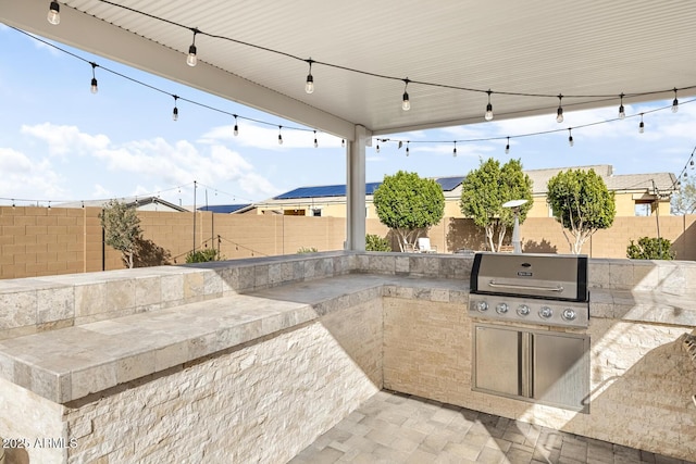 view of patio featuring area for grilling, an outdoor kitchen, and a fenced backyard