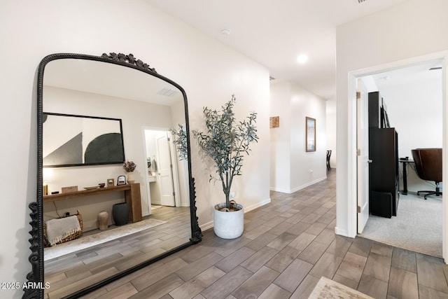 corridor featuring recessed lighting, wood finished floors, and baseboards