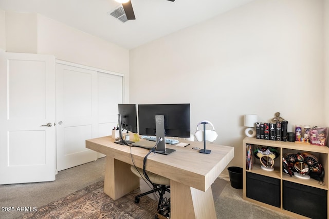 carpeted office with visible vents and ceiling fan