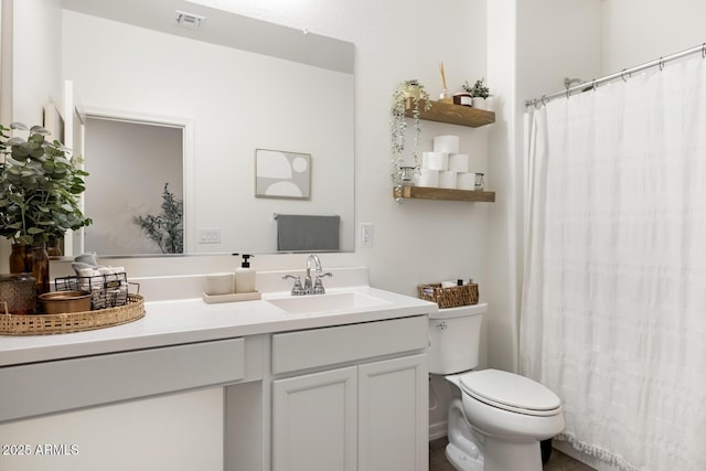 full bath with visible vents, toilet, and vanity