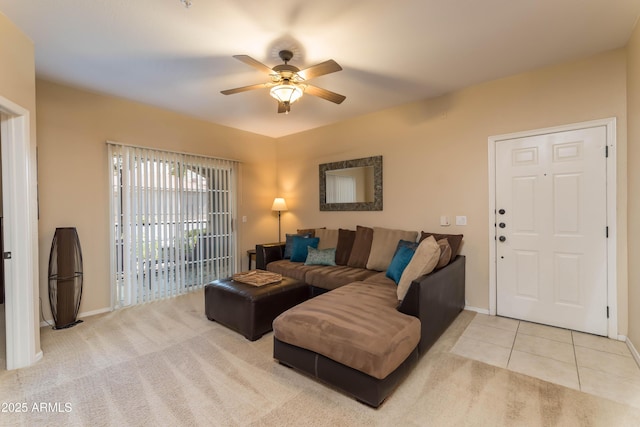 carpeted living room with baseboards, ceiling fan, and tile patterned flooring