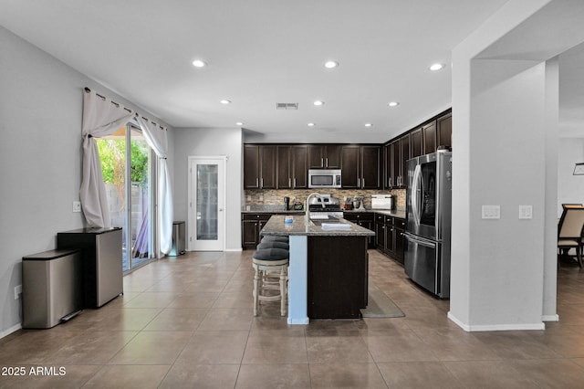 3436 E Gary Way, Gilbert, AZ 85234 - kitchen with stone countertops, stainless steel appliances, visible vents, recessed lighting, and backsplash