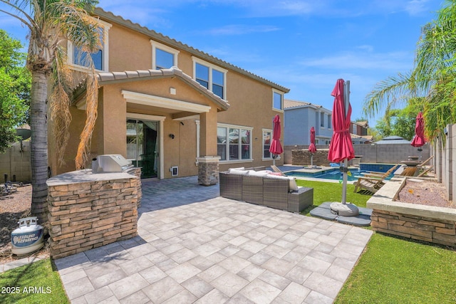 3436 E Gary Way, Gilbert, AZ 85234 - back of house with a fenced backyard, stucco siding, a patio, and exterior kitchen