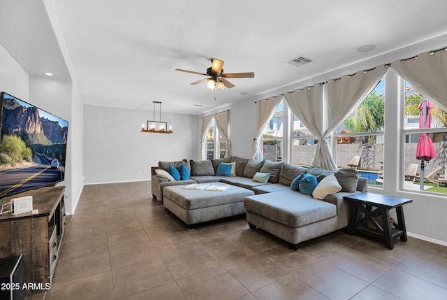 3436 E Gary Way, Gilbert, AZ 85234 - tiled living room featuring ceiling fan with notable chandelier, baseboards, and visible vents