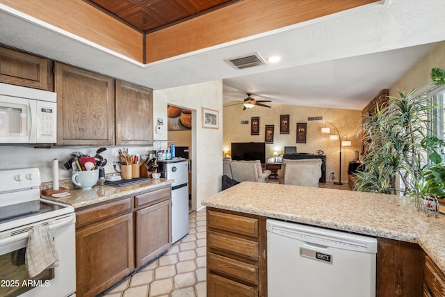 kitchen with white appliances, light countertops, ceiling fan, and a peninsula