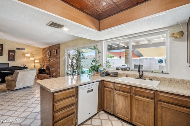 kitchen with white dishwasher, a sink, a peninsula, light countertops, and an ornate ceiling