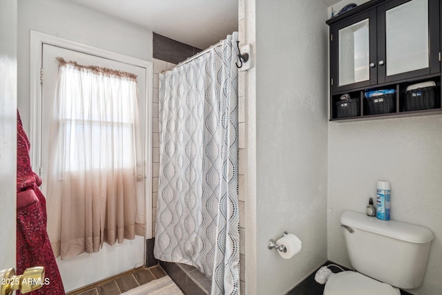 full bathroom featuring wood finished floors and toilet