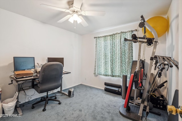carpeted office with a ceiling fan and baseboards