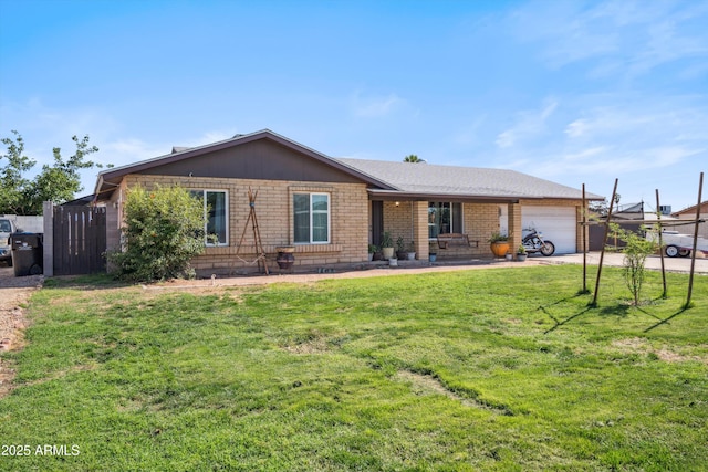 ranch-style house featuring a garage, a front yard, driveway, and brick siding
