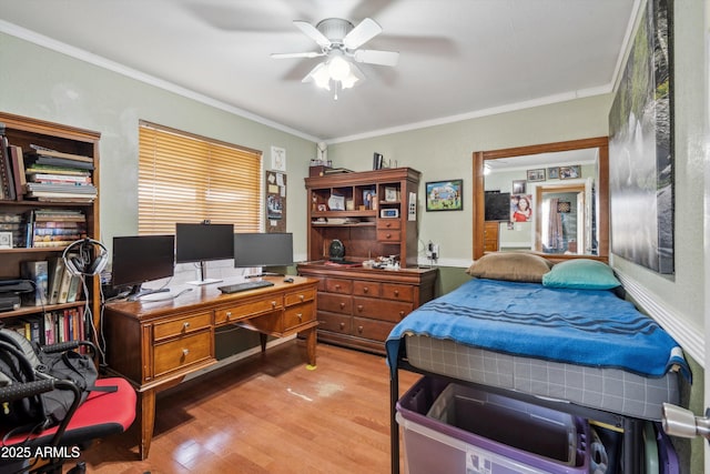 bedroom featuring wood finished floors, a desk, and ornamental molding