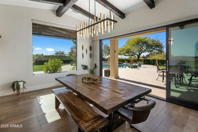 dining room featuring visible vents, plenty of natural light, hardwood / wood-style flooring, and lofted ceiling with beams
