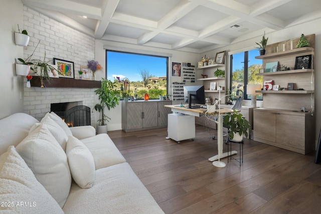 office featuring a fireplace, dark wood finished floors, visible vents, beam ceiling, and coffered ceiling