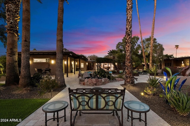 view of patio terrace at dusk