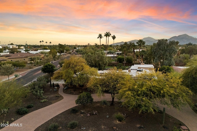 aerial view at dusk featuring a mountain view