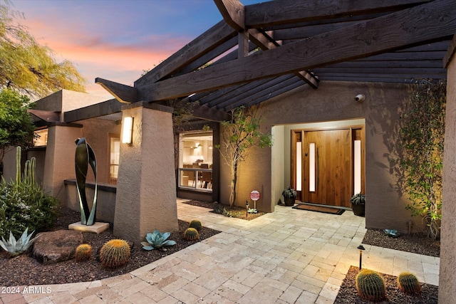 patio terrace at dusk with a pergola