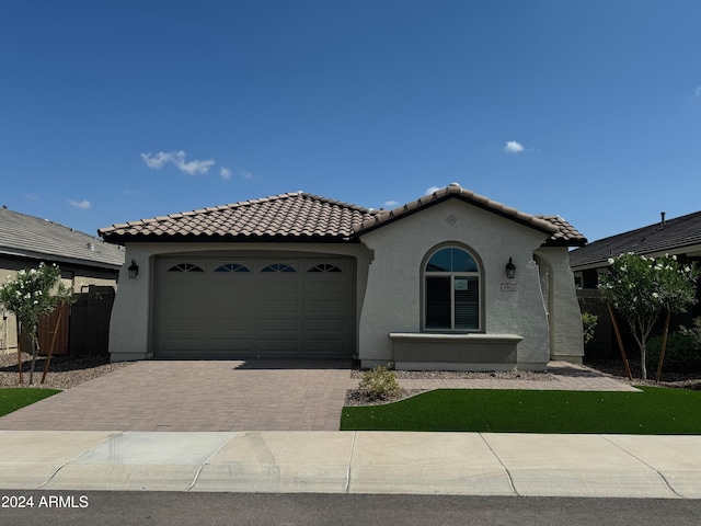 mediterranean / spanish-style house with a garage