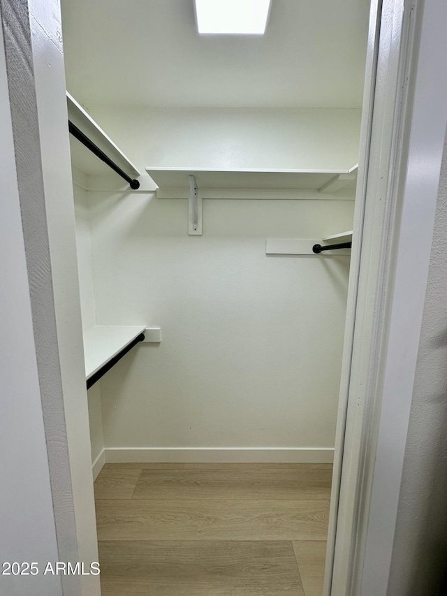 walk in closet featuring light hardwood / wood-style flooring