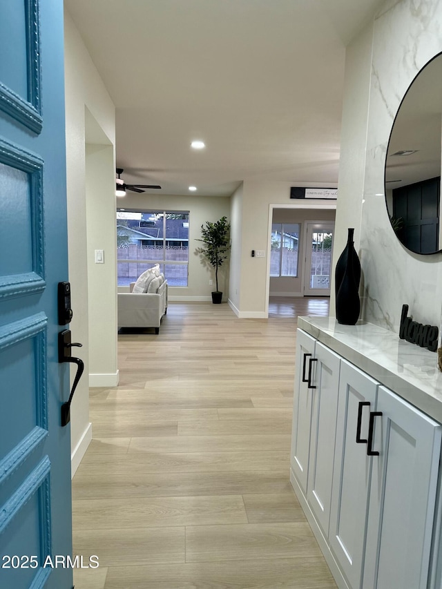 hallway with light hardwood / wood-style floors