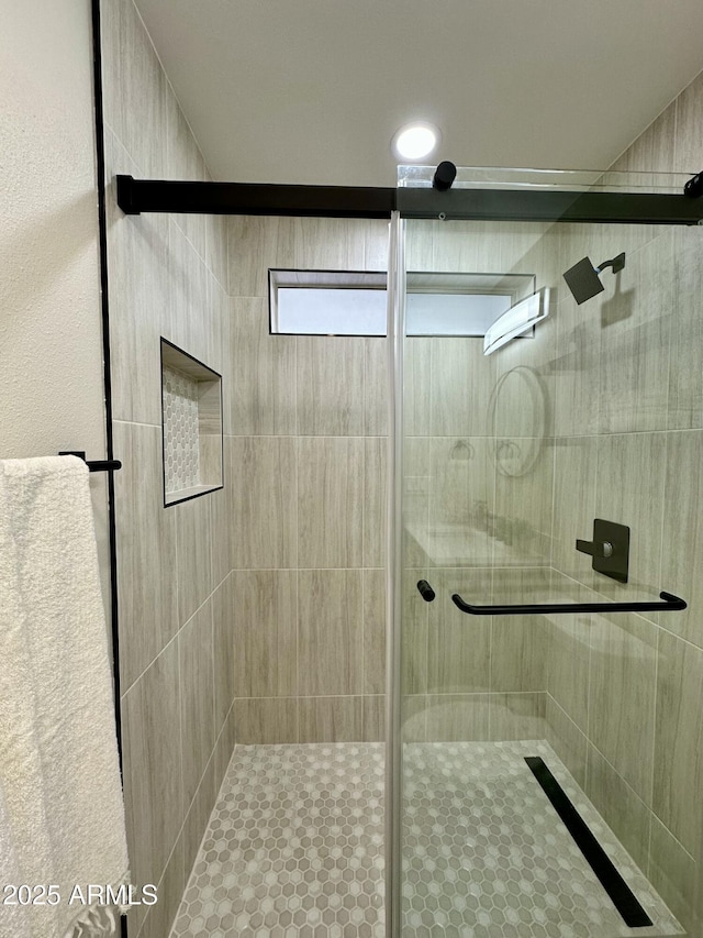 bathroom with a shower with shower door