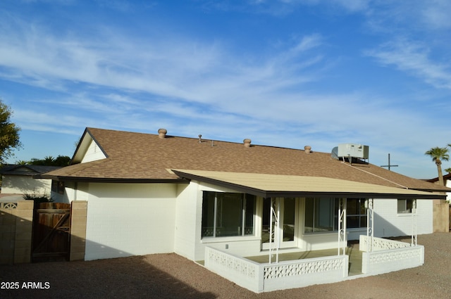 rear view of house featuring a patio area and central AC unit