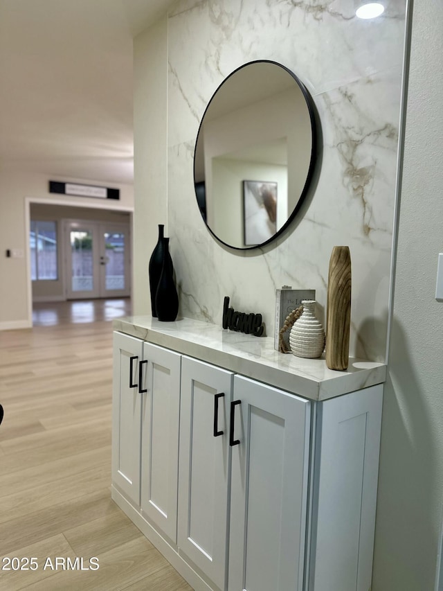 interior details featuring hardwood / wood-style flooring and decorative backsplash