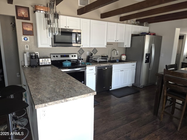 144 N Cactus Rd, Apache Junction, AZ 85119 - kitchen featuring stainless steel appliances, a sink, dark wood-style flooring, white cabinets, and beam ceiling