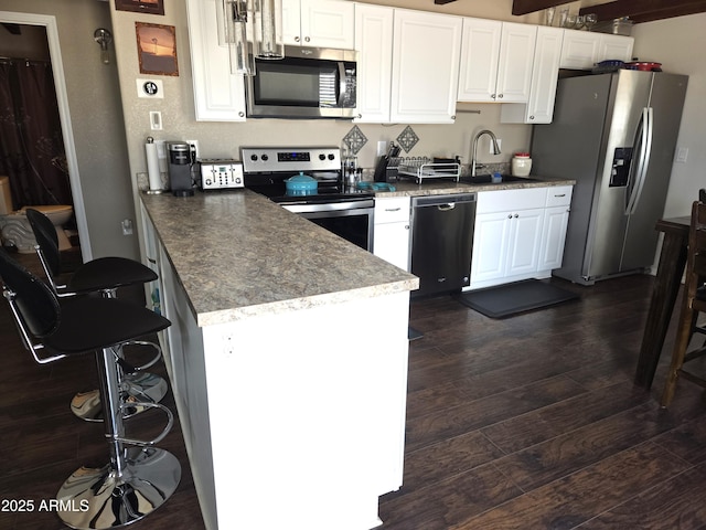 144 N Cactus Rd, Apache Junction, AZ 85119 - kitchen featuring stainless steel appliances, a sink, white cabinets, and dark wood-style flooring