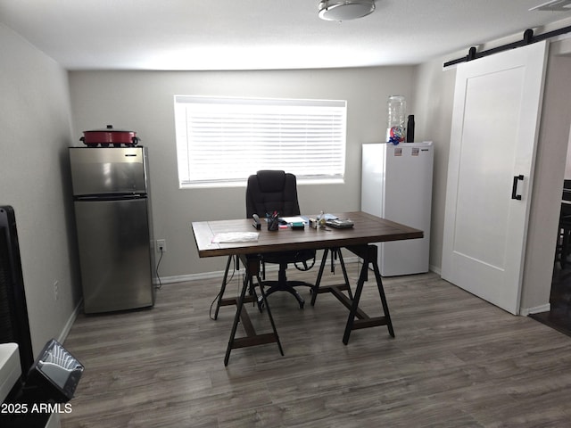 144 N Cactus Rd, Apache Junction, AZ 85119 - home office with a barn door, wood finished floors, and baseboards