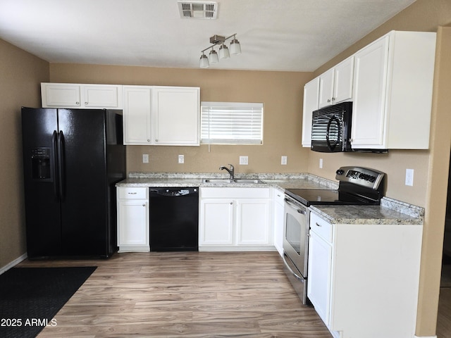 144 N Cactus Rd, Apache Junction, AZ 85119 - kitchen featuring black appliances, a sink, white cabinets, and light wood-style flooring