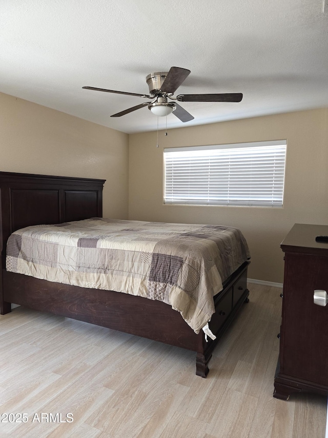 144 N Cactus Rd, Apache Junction, AZ 85119 - bedroom with light wood-style flooring, a ceiling fan, and baseboards