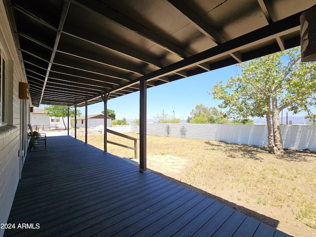 wooden terrace featuring a fenced backyard