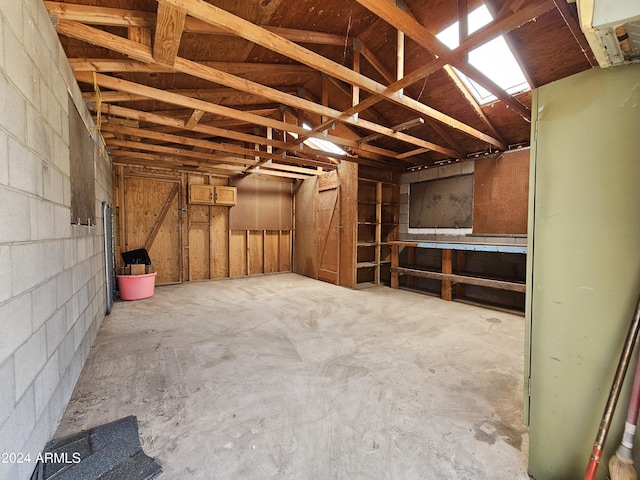 interior space with a garage and concrete block wall