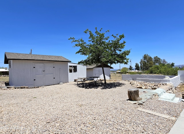 view of yard with an outdoor structure and a storage unit