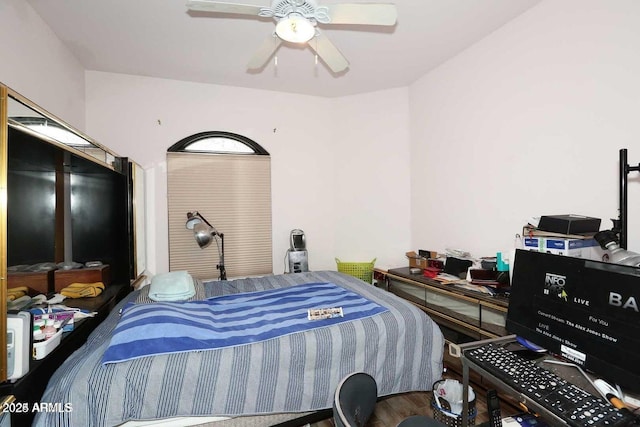 bedroom featuring a ceiling fan and wood finished floors