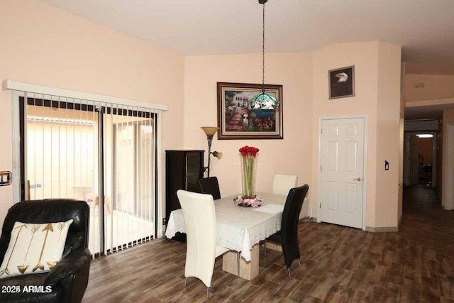 dining area with lofted ceiling, dark wood finished floors, and baseboards