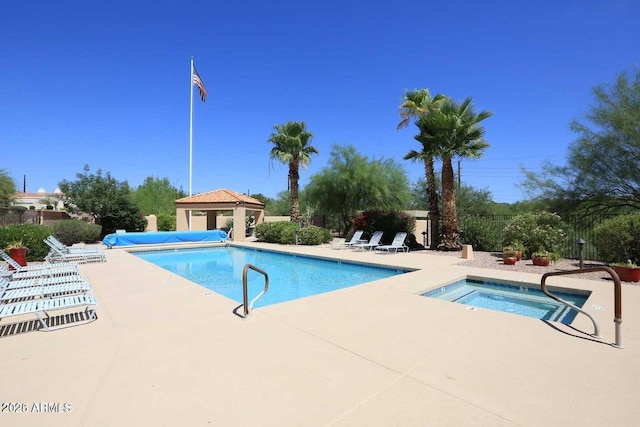 pool featuring a patio area, a hot tub, fence, and a gazebo