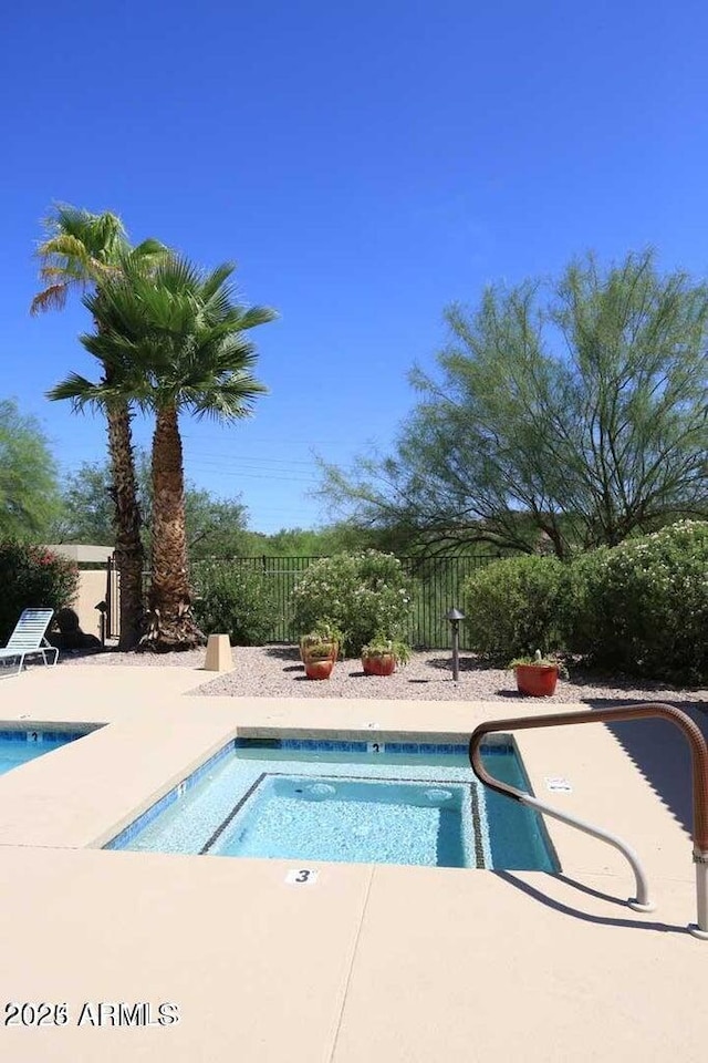 view of pool featuring a swimming pool, a patio area, and fence