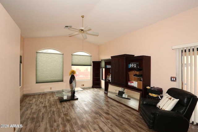 living area with a ceiling fan, lofted ceiling, visible vents, and wood finished floors