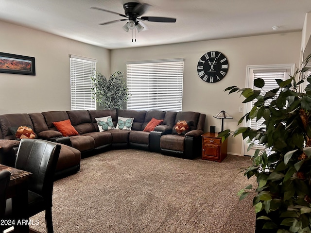 carpeted living room featuring ceiling fan and a healthy amount of sunlight