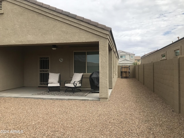 rear view of house featuring a patio area and ceiling fan