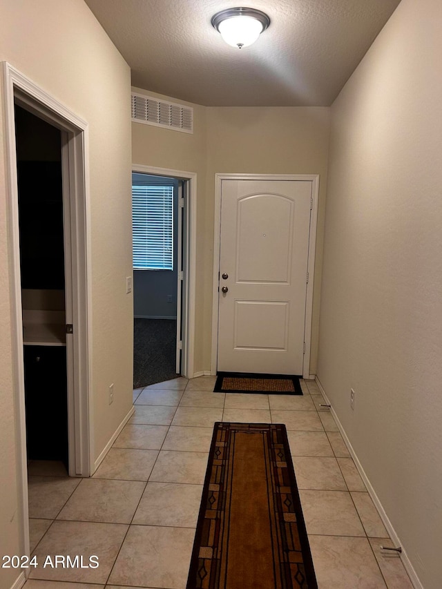 entryway with light tile patterned floors