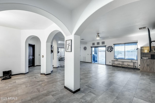 unfurnished living room with visible vents