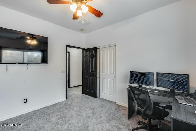 carpeted office space featuring a ceiling fan, baseboards, and visible vents