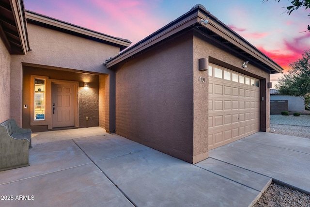 view of garage at dusk