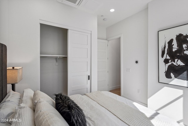 bedroom with a closet and hardwood / wood-style flooring