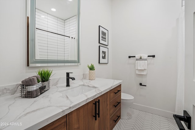 bathroom with tile patterned floors, vanity, toilet, and a tile shower